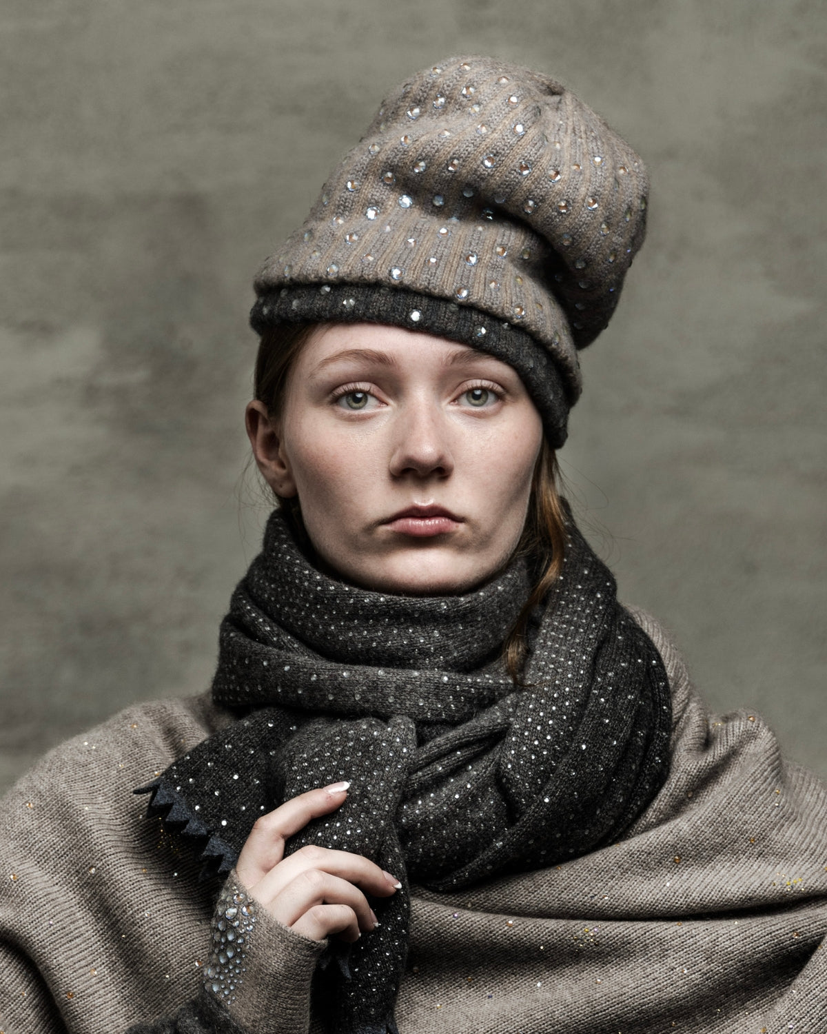 Model wearing a Super Deluxe Crystal Hats in Platinum (top) and Derby Grey (bottom). editorial-image